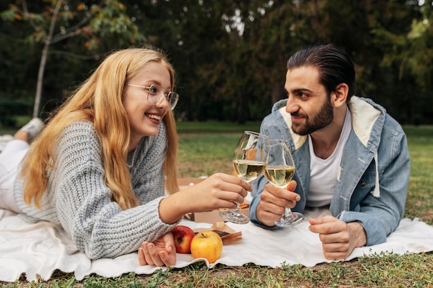 Foto vista frontal de la pareja con una copa de vino fuera