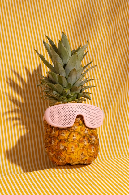 Foto vista de fruta de piña con gafas de sol frescas.