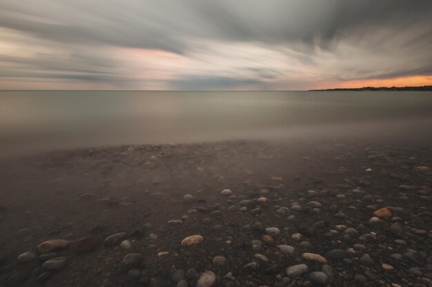 Vista idílica de la playa contra el cielo durante la puesta de sol