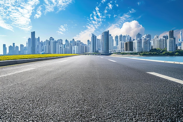 Vista lateral de la carretera asfaltada con jardín en el lago y el moderno horizonte de la ciudad en segundo plano.