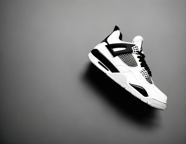Foto vista lateral de zapatos deportivos en blanco y negro una zapatilla de deporte en un fondo gris copia el espacio generado por la ia