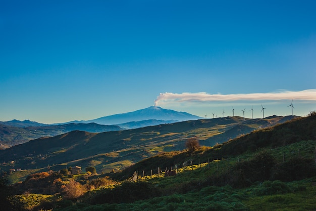 Vista de molinos de viento y el volcán Etna