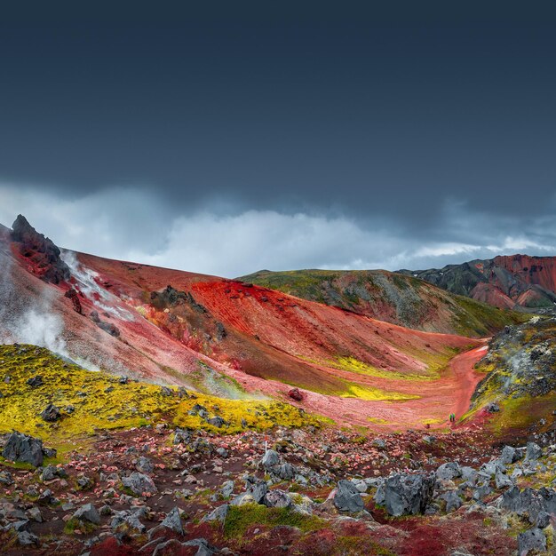 Foto vista del paisaje de coloridas montañas volcánicas de arco iris landmannalaugar y la famosa ruta de senderismo laugavegur con cielo dramático y nieve en el verano de islandia