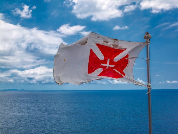 Foto vista panorámica de la bandera contra el mar y el cielo.