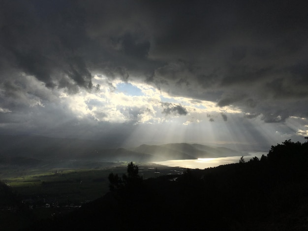 Vista panorámica del campo y el lago contra el cielo nublado