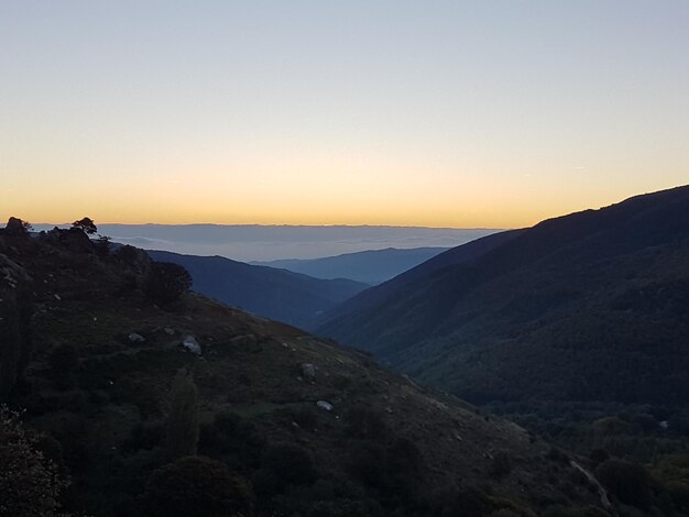 Foto vista panorâmica das montanhas contra o céu claro durante o pôr-do-sol