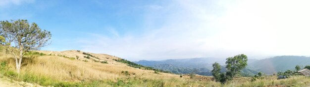 Vista panorâmica de campos e montanhas contra o céu azul