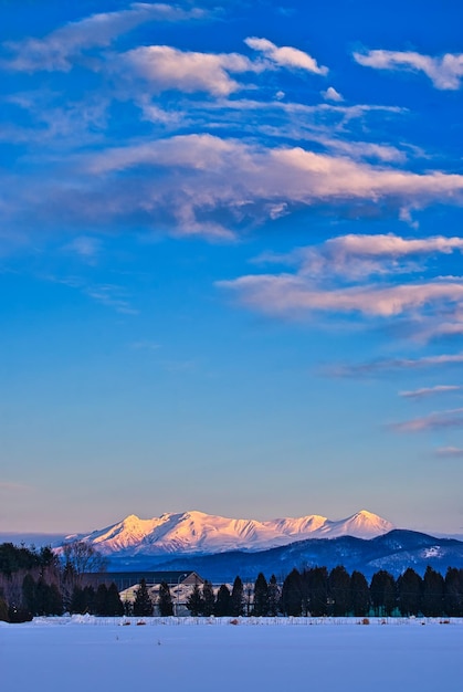 Foto vista panorâmica de montanhas cobertas de neve contra o céu durante o pôr-do-sol