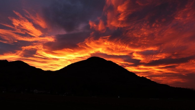 Vista panorâmica de silhuetas de montanhas contra o céu dramático