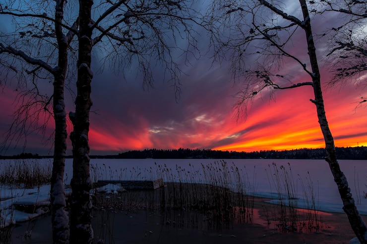 Foto vista panorâmica de um lago congelado contra um céu nublado durante o pôr-do-sol