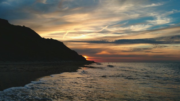 Vista panorâmica do mar ao anoitecer contra o céu nublado