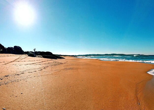 Vista panorámica de la playa contra un cielo azul despejado