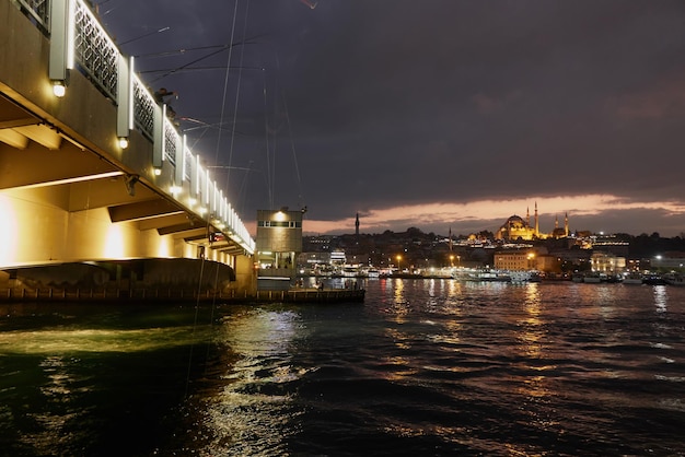 Vista panorámica del puente Galata con pescadores en la noche Turquía Estambul