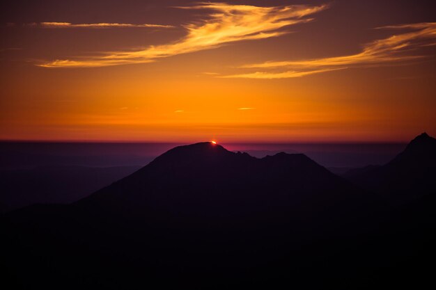 Foto vista panorámica de las siluetas de las montañas contra el cielo durante la puesta de sol