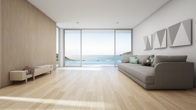 Vista para o mar sala de estar da casa de praia de luxo com piscina e terraço de madeira.