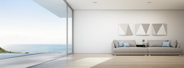 Vista para o mar sala de estar da casa de praia de luxo com piscina e terraço de madeira.