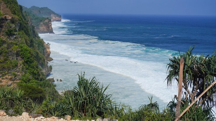 vista de la playa desde la parte superior del acantilado pequeñas olas y espuma blanca