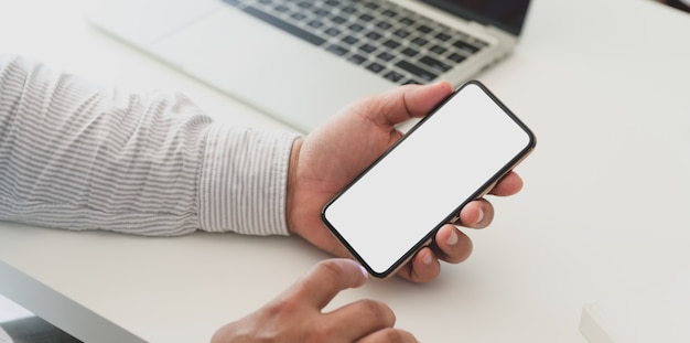 Vista de primer plano del empresario profesional con smartphone de pantalla en blanco