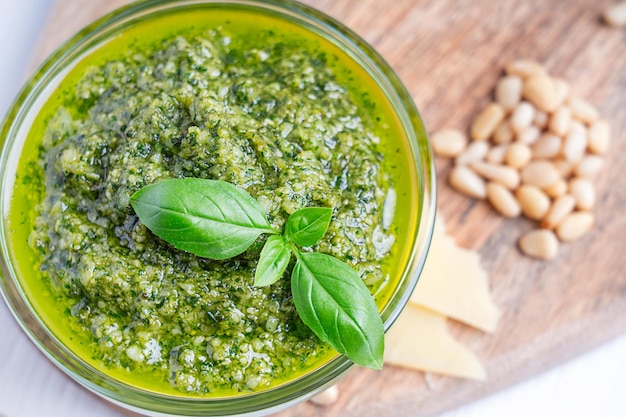 Vista próxima do molho pesto caseiro italiano feito de folha de manjericão, pinhões, parmesão e azeite