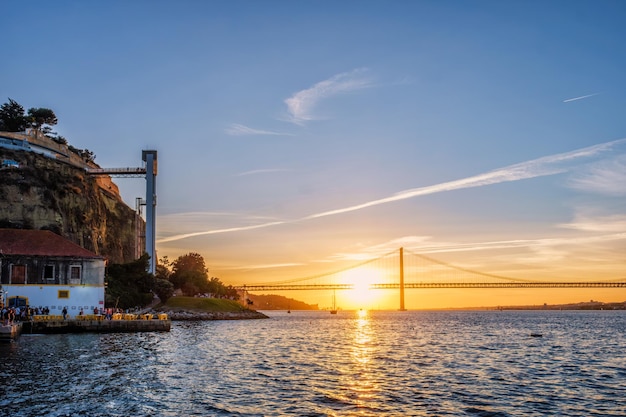 Vista del puente de Abril sobre el río Tajo al atardecer en Lisboa, Portugal