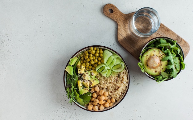 Vista superior almuerzo de verduras saludables con quinoa, aguacate, garbanzos y pepino