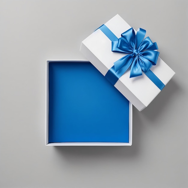 Foto vista superior de caja de regalo abierta con interior azul sobre fondo gris