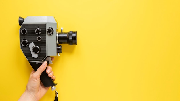 Vista superior câmera de filme vintage em fundo amarelo com espaço de cópia