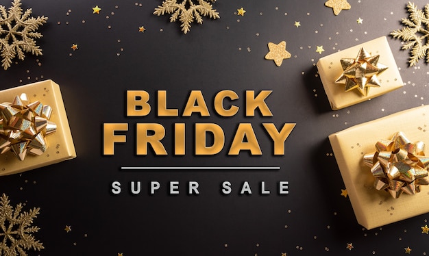 Vista superior da caixa de presente de Natal de sexta-feira negra e floco de neve dourado em fundo escuro. Dia de boxe de conceito de compras e composição de Black Friday.