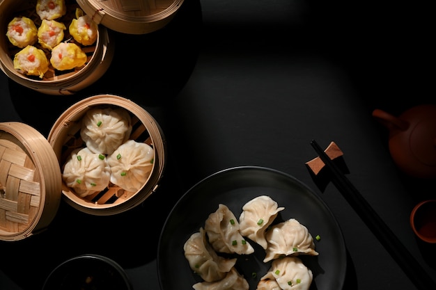 Vista superior de Dimsum no prato e vapor de bambu com bolinhos na mesa e espaço de cópia em restaurante chinês