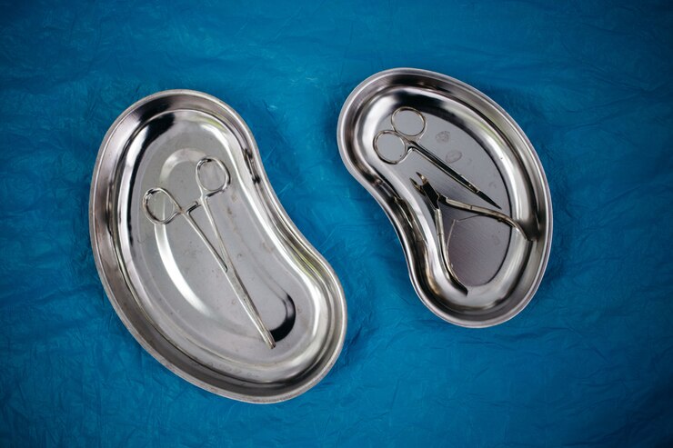 Vista superior de instrumentos médicos na bandeja, luvas descartáveis no azul. saúde