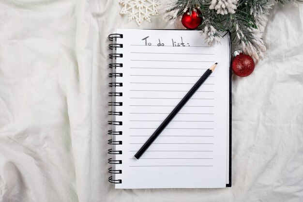 Vista superior do caderno em branco para lista de tarefas e decoração de Natal