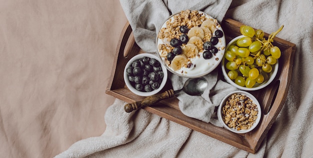 Foto vista superior do café da manhã na cama com cereais e uvas