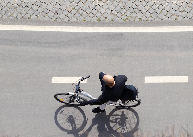 Vista superior do homem careca andando de bicicleta dando um passeio pela cidade europeia