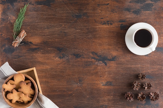 Vista superior do laptop, homem-biscoito, xícara de café no escuro de madeira rústica