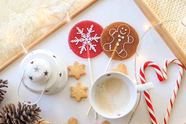 Vista superior do pirulito de doces de Natal vermelho e caramelo com floco de neve e homem de gengibre