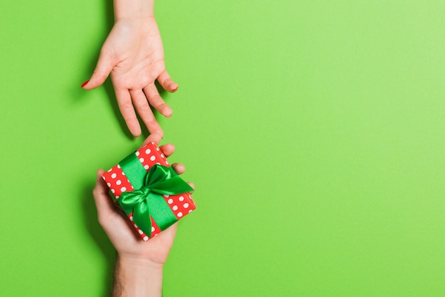 Vista superior de un hombre y una mujer sosteniendo una caja de regalo. Concepto de amor y relación. Copia espacio