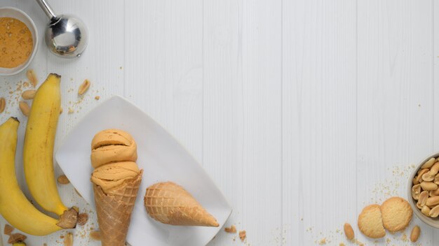 Vista superior del postre de verano con conos de helado de sabor a plátano y mantequilla de maní