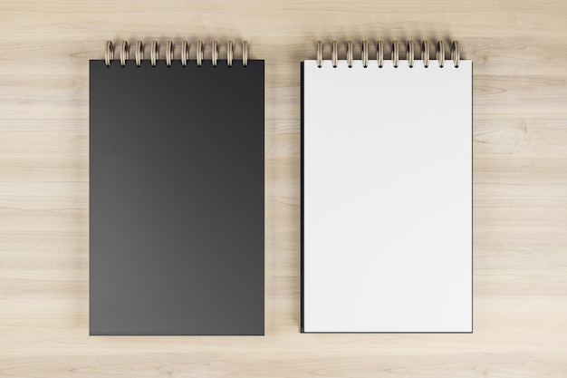 Vista superior y primer plano de dos cuadernos de primavera blancos y negros en un fondo de escritorio de madera Modelo de lugar para su anuncio Educativo suministros de trabajo y artículos de papelería concepto Rendering 3D