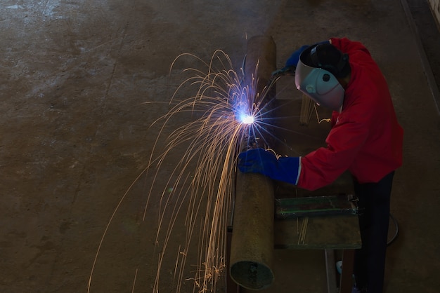 vista superior Soldadores que trabajan en el metal hecho en fábrica