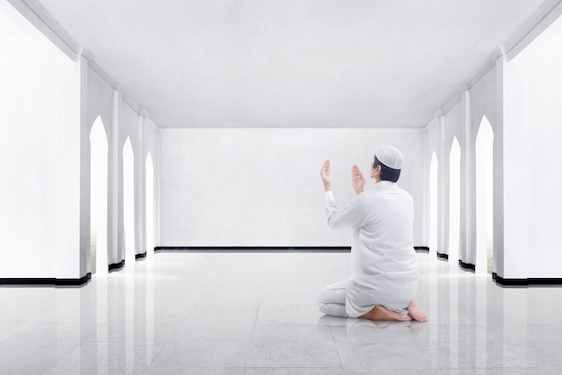 Vista traseira, de, asian muçulmano, ajoelhando, e, orando, para, deus