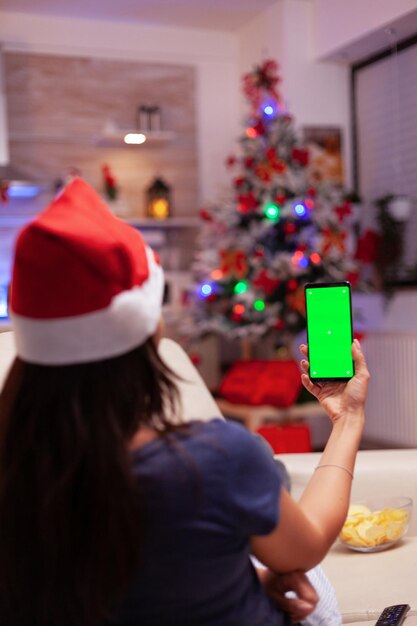 Foto vista traseira de mulher segurando árvore de natal em casa