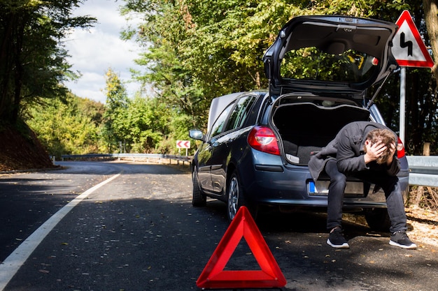 Vista traseira de um homem na estrada contra árvores na cidade