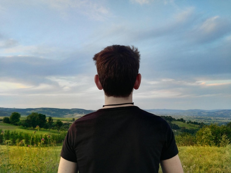 Foto vista traseira de um homem no campo contra o céu