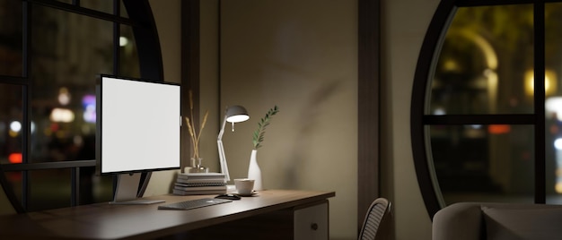 Vista traseira de uma sala de trabalho contemporânea moderna à noite com maquete de computador