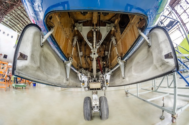 Foto vista del tren de aterrizaje frontal de la apertura del ala del chasis, el interior del mecanismo y muchas partes de la aeronave.