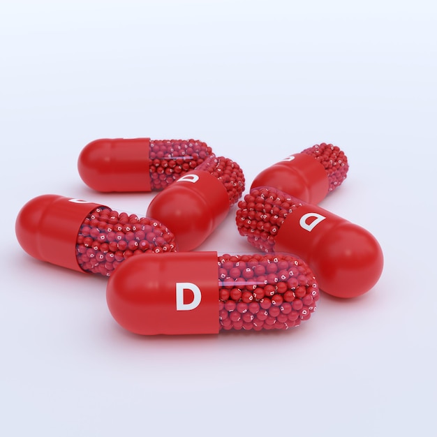 Foto vitamina d com grânulos de cápsulas vermelhas e fundo branco