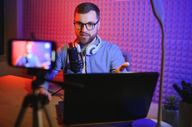 Vlogger masculino gravando vídeo em casa com a câmera