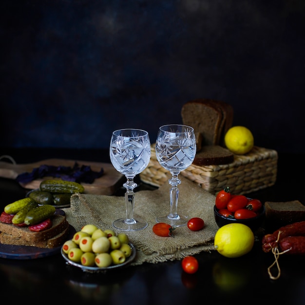 Vodka com guarnição de limão, azeitonas, pão