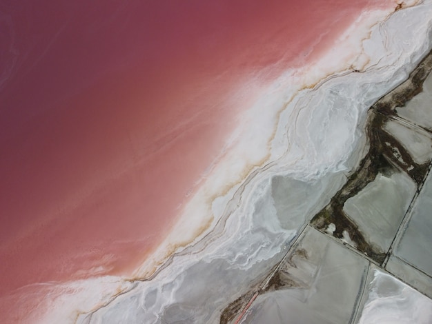 Volando sobre un lago salado rosa instalaciones de producción de sal salina campos de estanques de evaporación en el salado