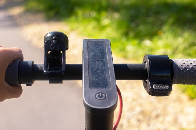 Volante de scooter eléctrico sobre un fondo de bosque verde